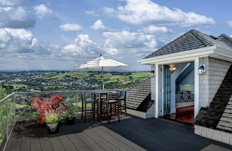 Terrace with parasol, seating and a countryside view